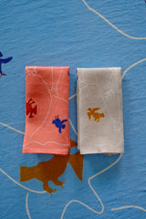 Asafo napkins with animal prints on a blue textured background