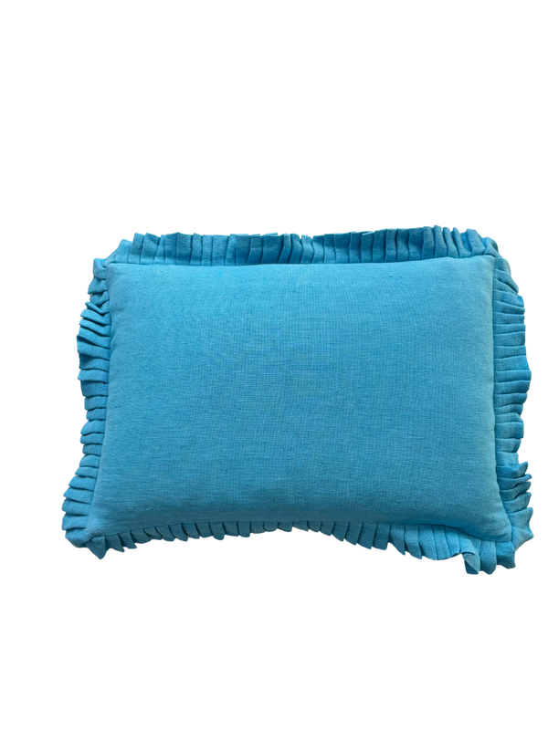 Blue pillow with ruffled edges on a white background