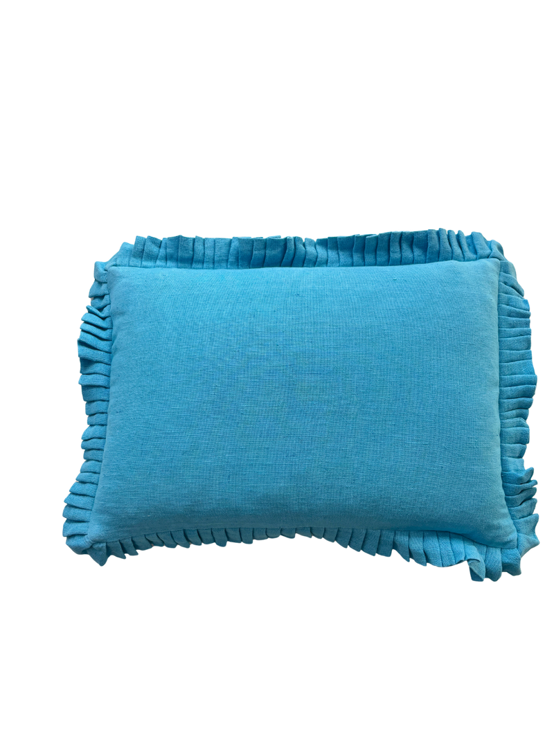 Blue pillow with ruffled edges on a white background