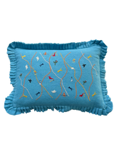 Blue pillow with embroidered designs 