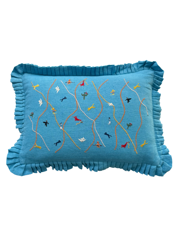 Blue pillow with embroidered designs 
