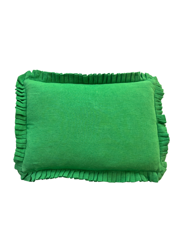 Green pillow with ruffled edges on a white background