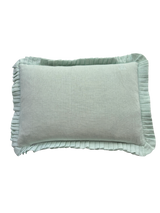 Light grey pillow with ruffled edge on a white background