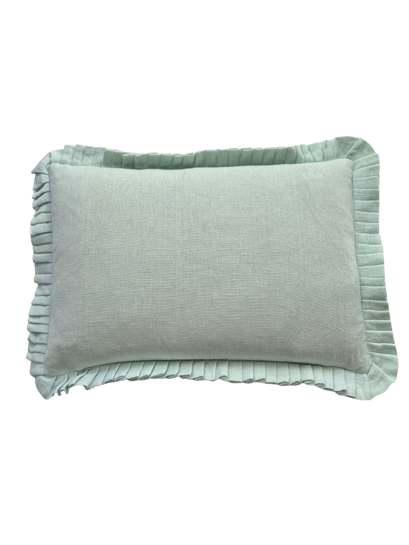 Light grey pillow with ruffled edge on a white background