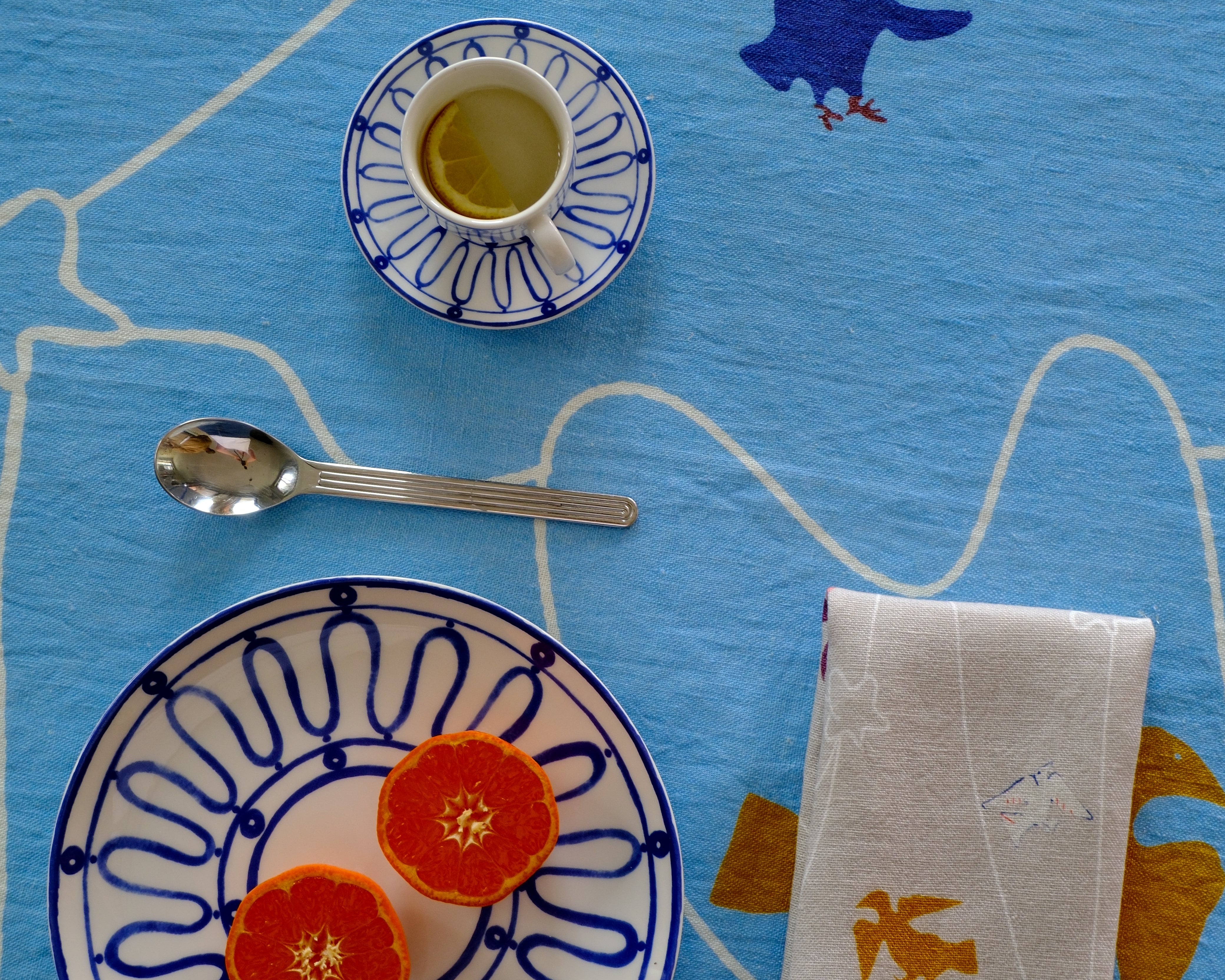 Ceramic plates with decorative patterns on a blue surface with animal illustrations