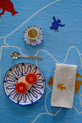 Ceramic plates with decorative patterns on a blue surface with animal illustrations